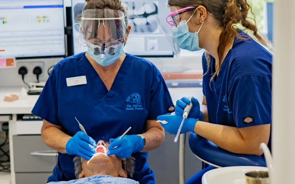 denture services at martock dental dentist working on implants